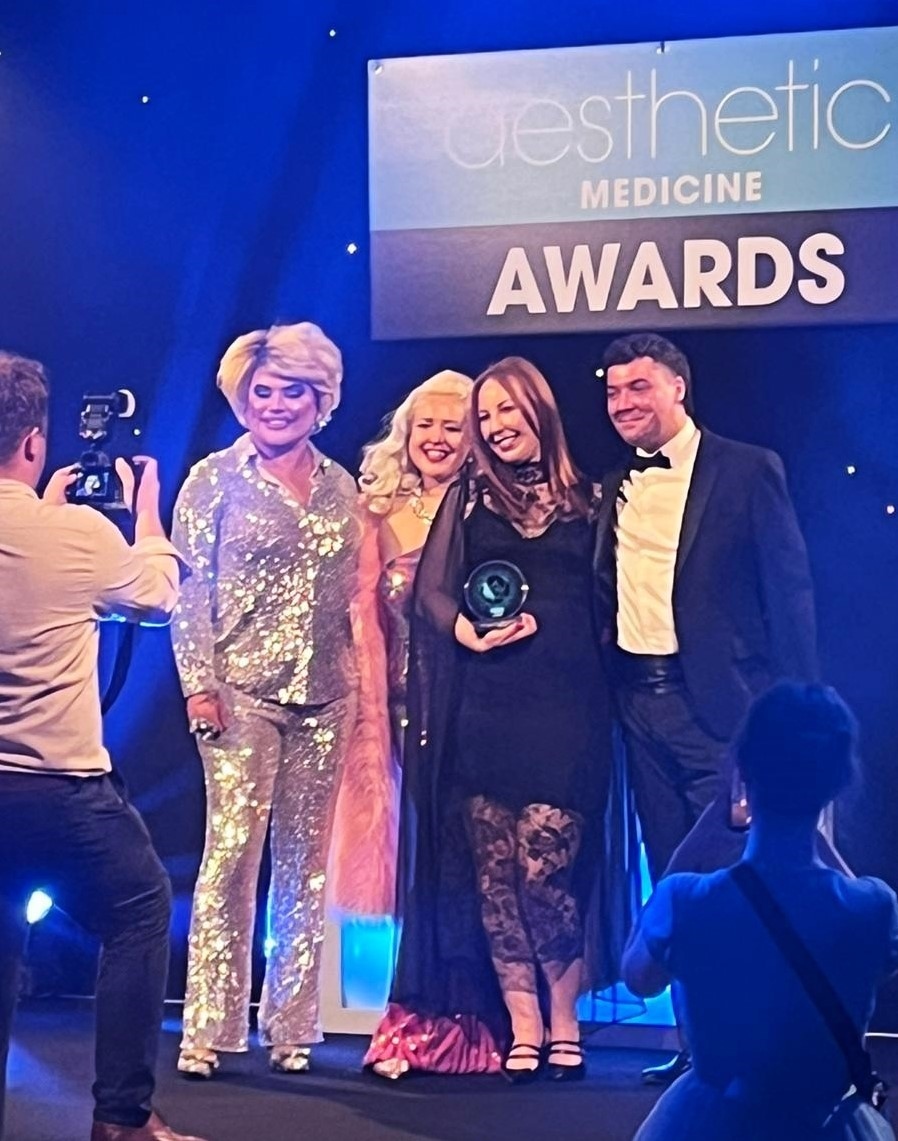 Sara Cheeney receives her award at the Aesthetic Medicine Awards.