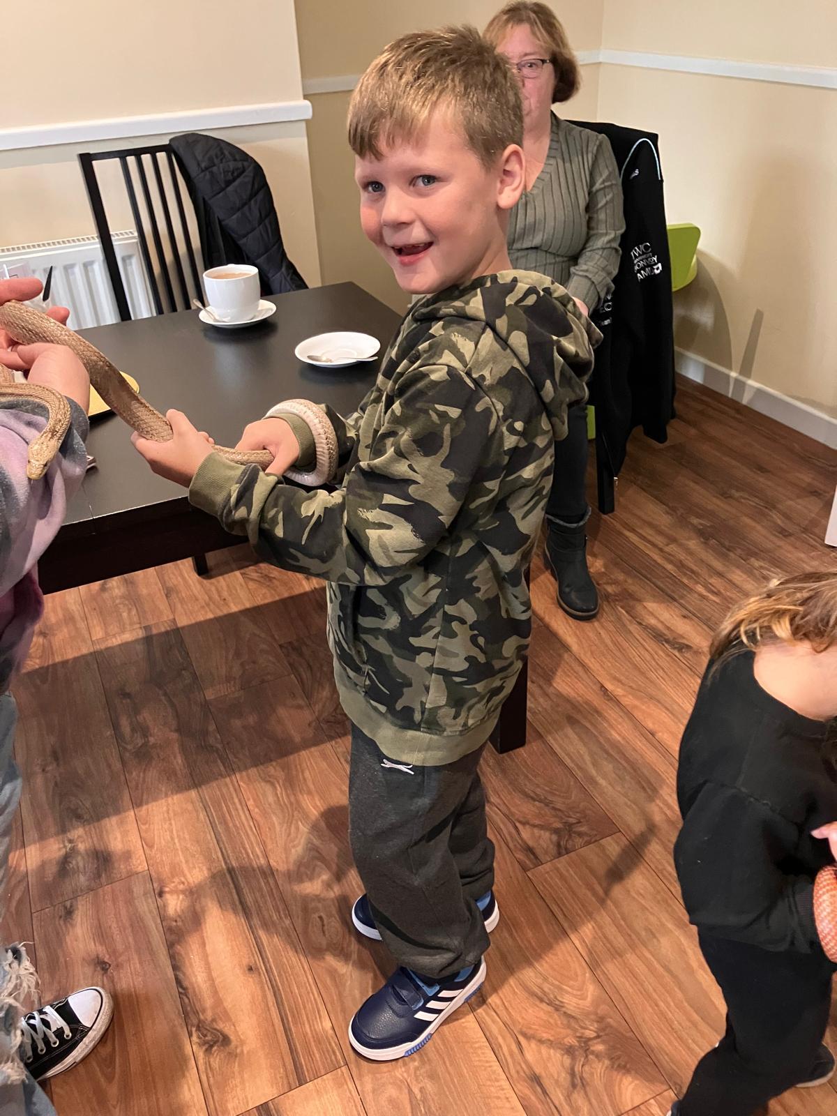 Logan meets a corn snake.